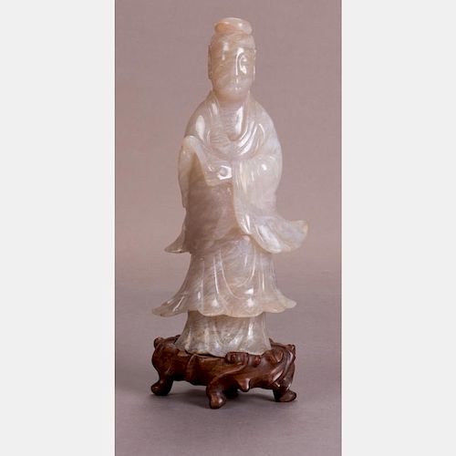 A Chinese Carved Nephrite Jade Figure of Guanyin on a Carved Hardwood Stand.