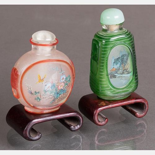 Two Peking Glass Snuff Bottles with Painted Interiors on Carved Hardwood Stands,
