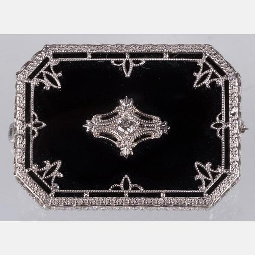 A 14kt. White Gold, Onyx and Diamond Brooch,