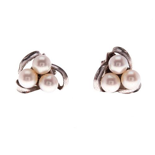 Par de broqueles vintage con perlas en metal base. 3 perlas cultivadas color blanco de 5 mm. Peso: 3.1 g.