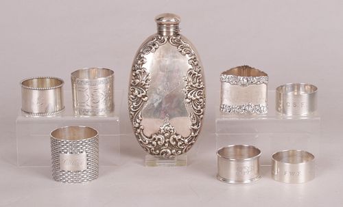 A Group of Silver Napkin Rings and a Flask