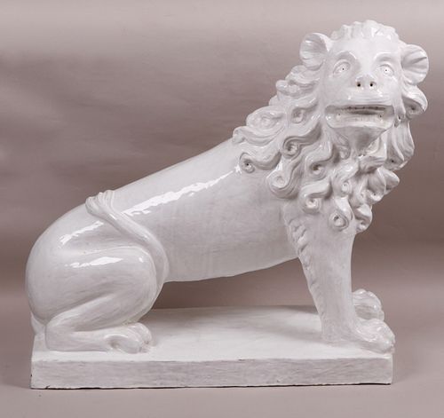 A Large French Faience Seated Lion