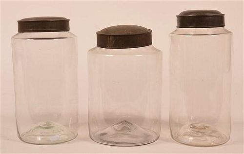 Three Blown Glass Canister Jars with Tin Lids.