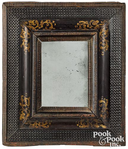 Continental ebonized and gilt decorated mirror