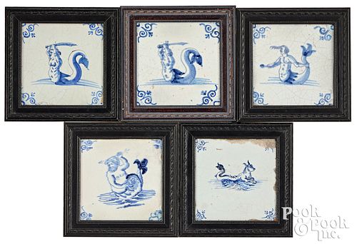 Five Delft blue and white sea creature tiles