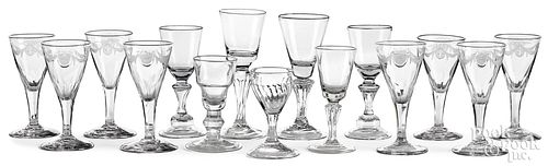Fifteen colorless glass cordials and wine glasses