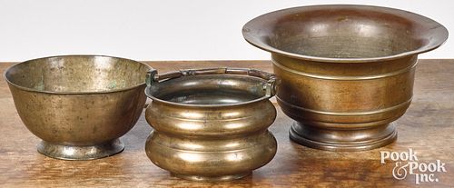 Three early brass bowls