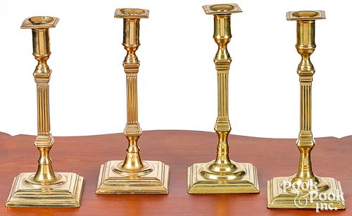 Four George III English brass candlesticks