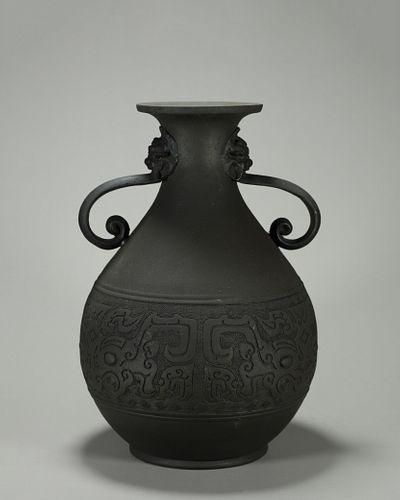 A taotie patterned copper vase with beast shaped ears