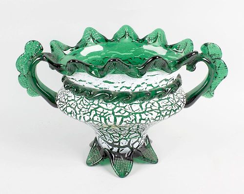 An enamelled green glass vase. Probably Bohemian, of oval form with crimped wavy rim over twin handl
