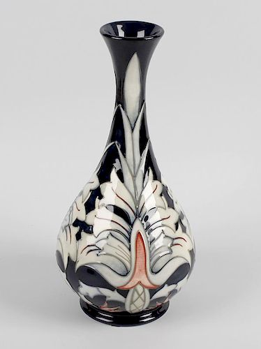 A Moorcroft pottery vase, the bulbous body with tall slender flared neck, the tube lined decoration