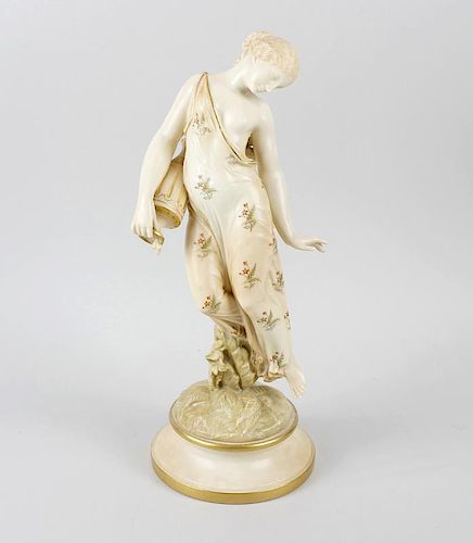 A Royal Worcester blush ivory figure, modelled as a female water carrier wearing sparse floral drape