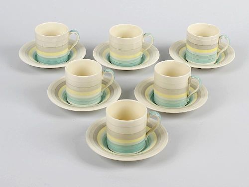 A Susie Cooper coffee set, comprising seven cups, six saucers and two milk jugs, having green, yello