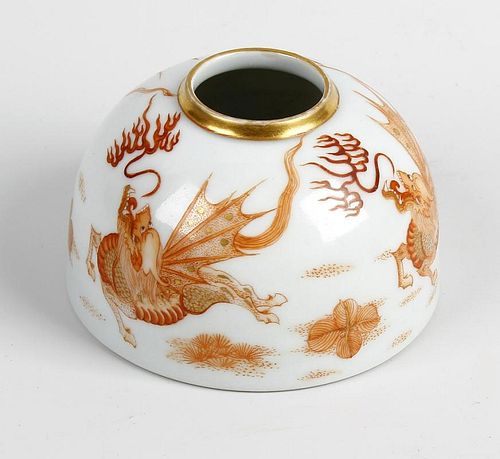 A Chinese porcelain brush pot or taibaizan. Of hemispherical form painted in burnt orange with drago