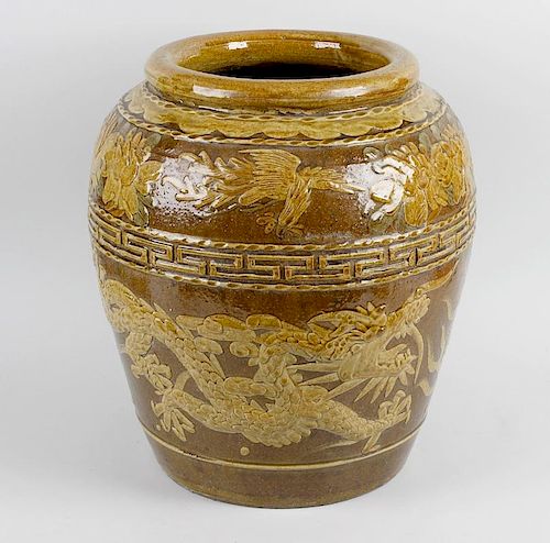 A large Chinese pottery jardinière, of ovoid form having rolled rim, decorated with band of dragons