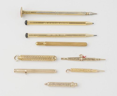 A small selection of gilt sleeved pencils, three with foliate engraving to barrels, one with 'cheque