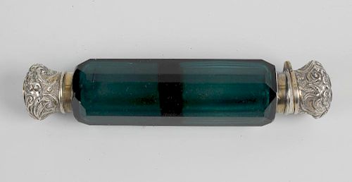 A Victorian green glass double ended scent bottle, of faceted cut form, capped with an embossed whit