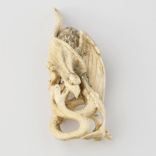 A Japanese Meiji period ivory okimono, modelled as an eagle attacking a snake, 4.5, (11.5cm) high, (