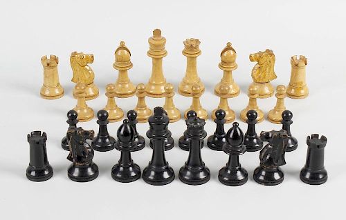 An oak cased Staunton pattern chess set, comprising ebonised and natural pieces each of turned form,