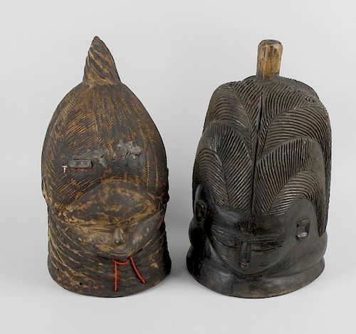 Two wooden Bundu helmet masks. Each modelled as a female head having extended forehead and small fac