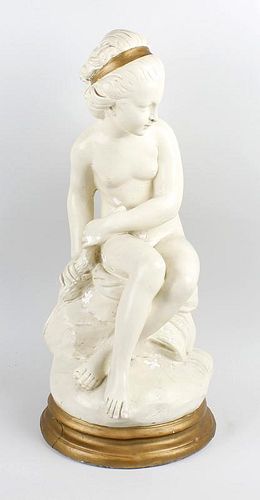 A Belgian plaster figure of a maiden. Early 20th century, modelled as a seated naked female wearing