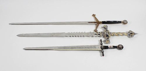 Four Marto Toledo replica swords, to include large cast metal example, the handle detailed with face
