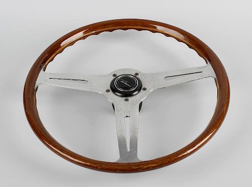 A Les Leston three spoke wooden rimmed steering wheel, each of the flat polished spokes with pierced