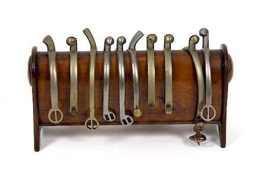 A Victorian mahogany spur standHaving ten spurs (including three pairs), most by Maxwell, on arched