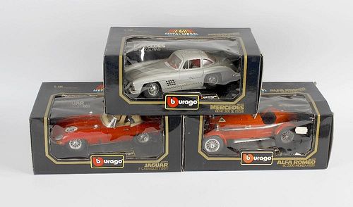 Three boxes containing six Burago 1.18 scale diecast and plastic model cars, each in original box, a