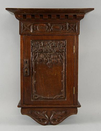 Arts & Crafts carved oak wall cupboard with floral decoration carved in relief, height 53cm, width 3
