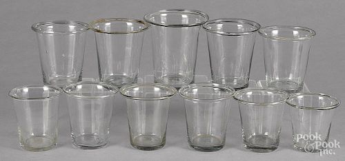 Eleven colorless glass beakers, 19th c., tallest - 4 1/2''.