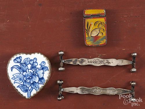 Pair of Austrian silver knife rests, together with a tin match safe