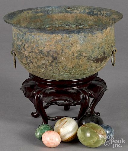 Chinese archaic bronze bowl, 5'' h., 10'' w., together with hardstone eggs.