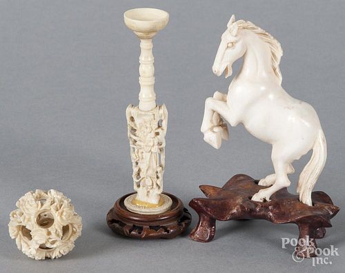 Chinese carved ivory horse, ca. 1900, 3 1/2'' h., together with a puzzle ball, 5 1/4'' h.