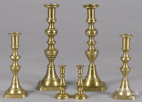 Three pairs of English brass candlesticks, late 19th c., 4'' h., 8'' h., and 11'' h.