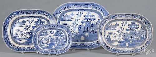 Four Ironstone Blue Willow platters, 19th c., largest - 14 1/4'' l., 18'' w.