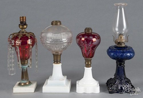 Four assorted glass fluid lamps, 19th c.