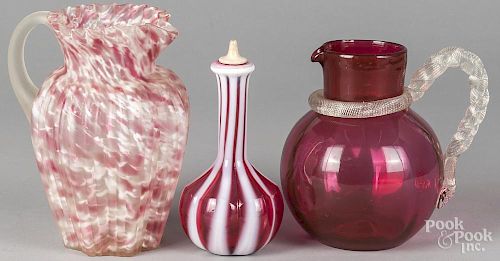 Two glass pitchers, 8 3/4'' h. and 7 1/2'' h., together with a ruby and opalene cruet, 8'' h.