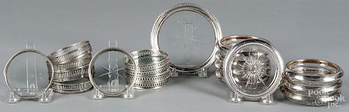 Nineteen sterling and silver-plate mounted coasters.