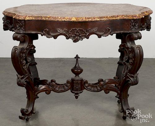 Victorian walnut marble top stand, 19th c., with a turtle-shaped top, a carved apron