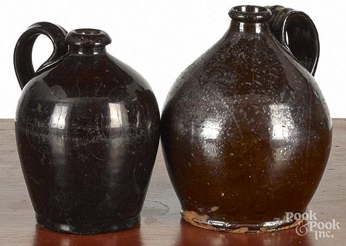 Two Pennsylvania redware jugs, 19th c., 7'' h. and 6 1/2'' h.