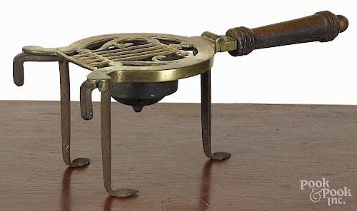 English brass and iron trivet, 19th c., stamped Longfields, with an unusual iron well for coals