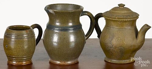 Three pieces of Stahl redware, dated 1938 and 1941, to include a mug, a pitcher, and a teapot