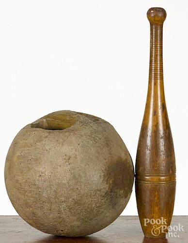 Unusual ball dumbbell weight, 19th c., with a carved handhold, 10'' h., together with an Indian club