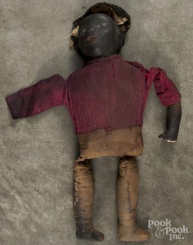 Early black Americana cloth doll, 19th c., with a heavy painted cloth face and wooden teeth, 19'' h.