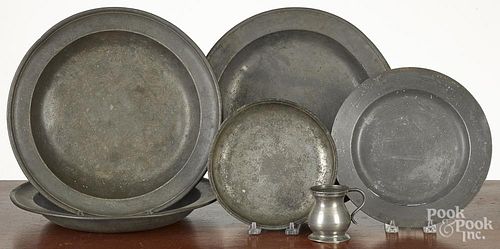 Six pieces of English pewter, 19th c., to include shallow bowls, a plate, and a measure