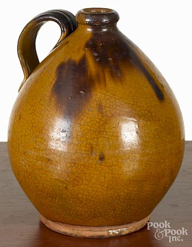 New England ovoid redware jug, 19th c., with manganese splotching, 10 1/2'' h.