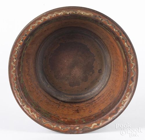 Pennsylvania or Maryland redware mixing bowl, 19th c., with yellow and green slip decoration, 4'' h.