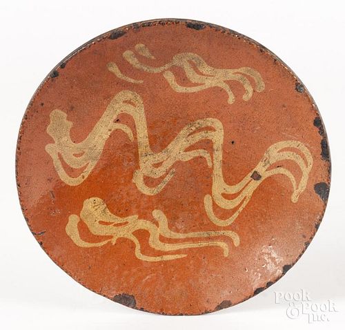Pennsylvania redware plate, early 19th c., with slip decorated wavy lines, 8 1/4'' dia.