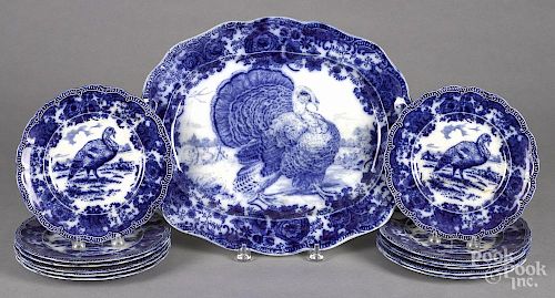 Ridgways flow blue turkey platter and twelve plates, 19th c., 14'' l., 17 1/2'' w., 9'' dia.